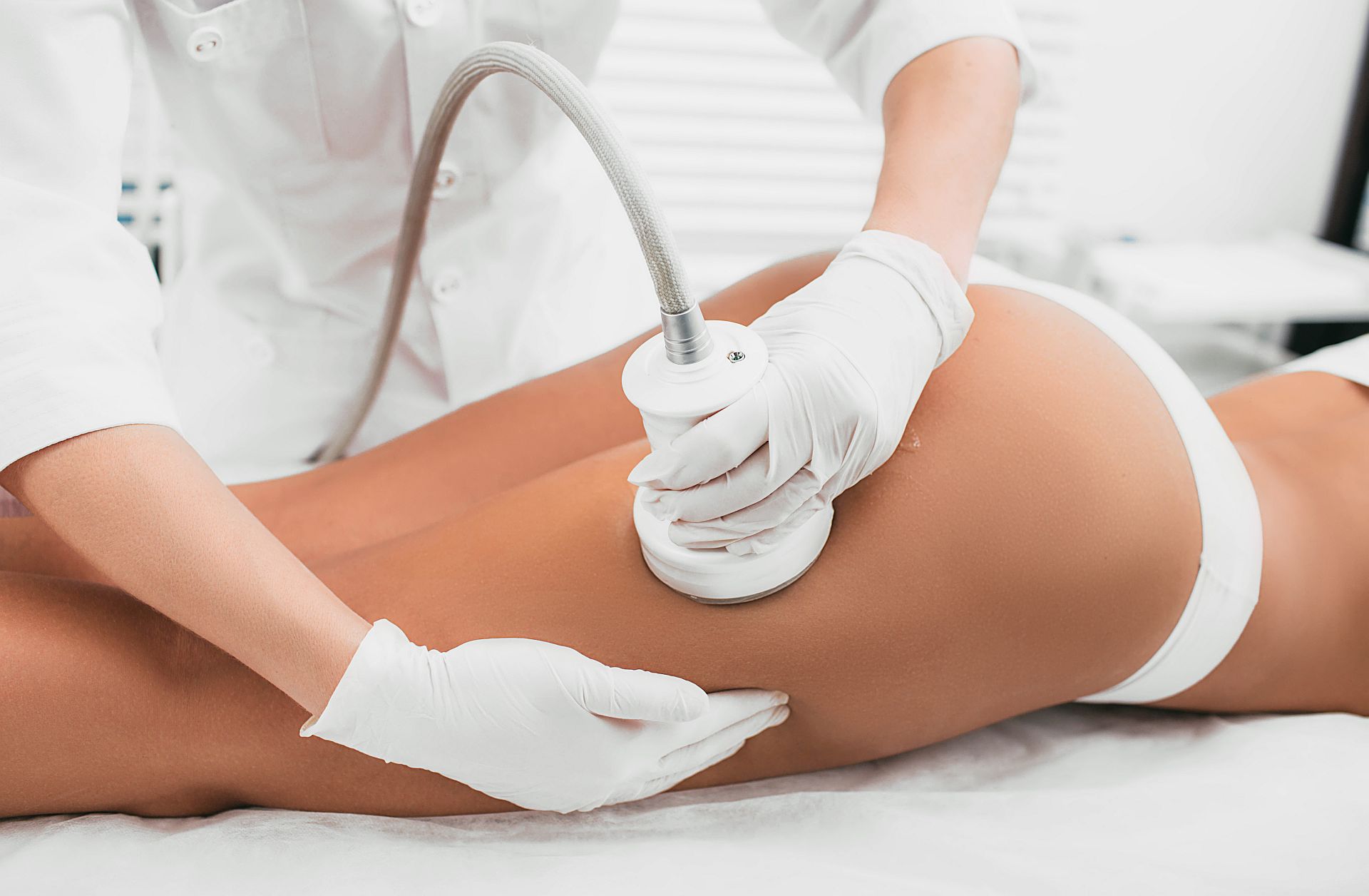 woman having cavitation procedure, cellulite treatment, on her buttocks and legs