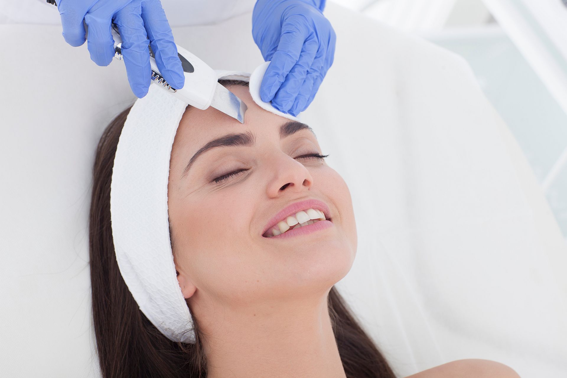 Beautiful woman is having a facial treatment in spa. Cavitation peeling.